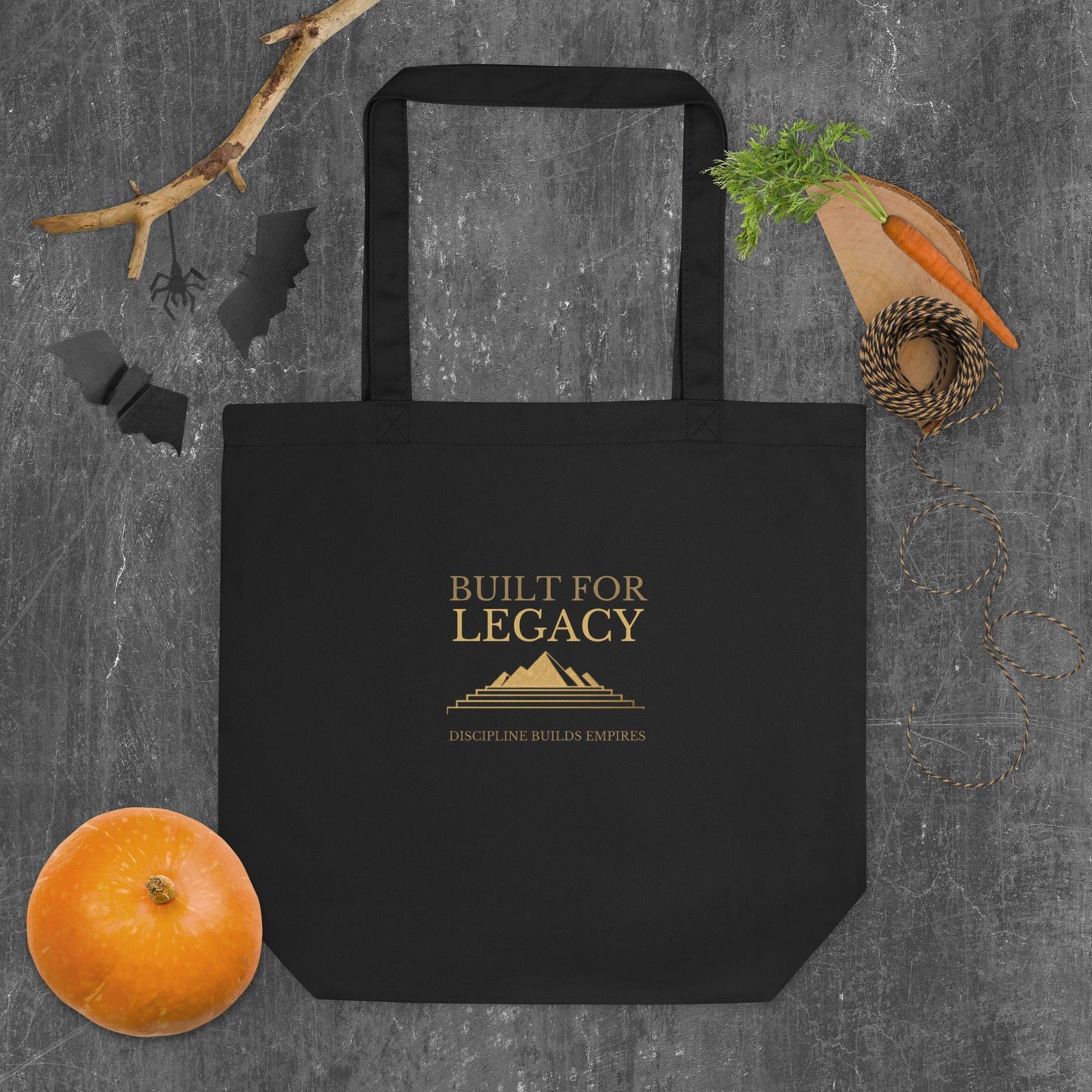 Black tote bag with “Built for Legacy” logo text on the front and top handles