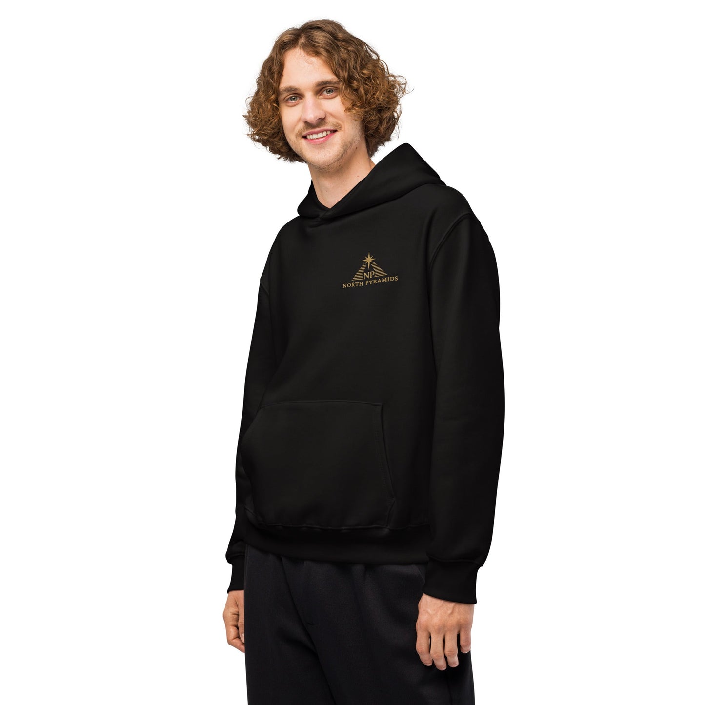 Black oversized hoodie with hood and kangaroo pocket, side view with chest logo.