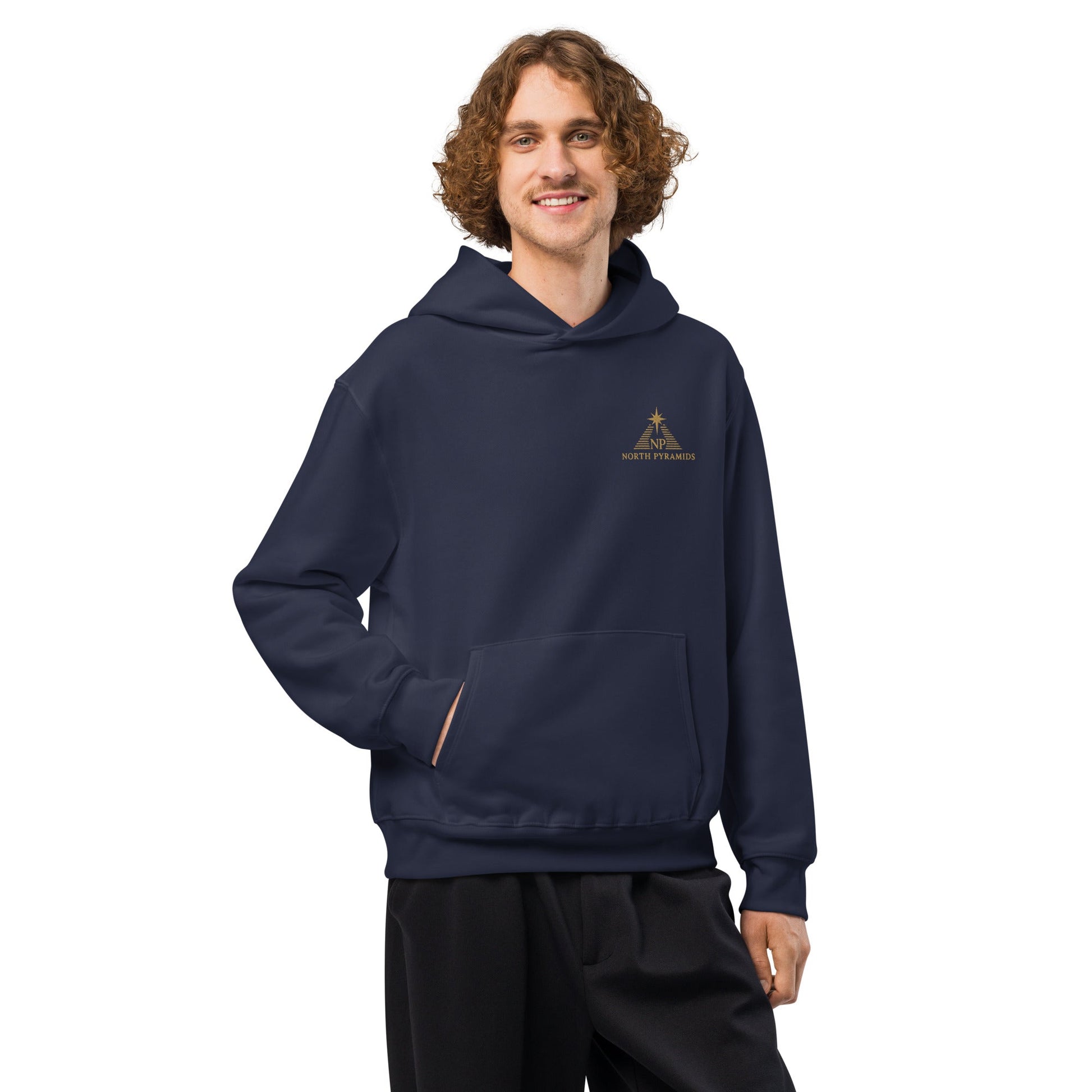 Navy oversized hoodie with hood, kangaroo pocket, and visible drawstring tips; logo on chest.