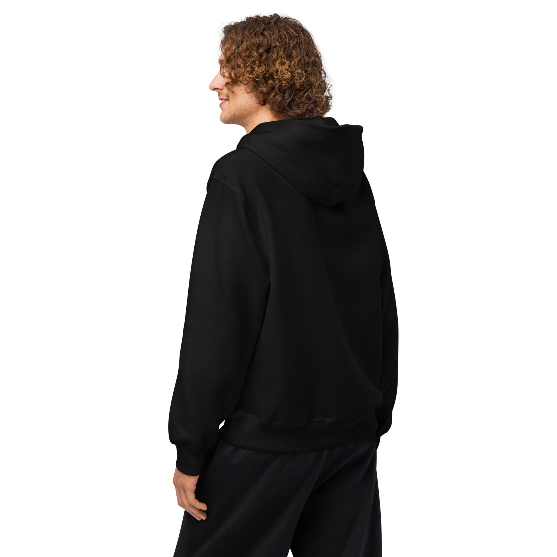 Black oversized hoodie shown from the side, with hood and full-length sleeves.