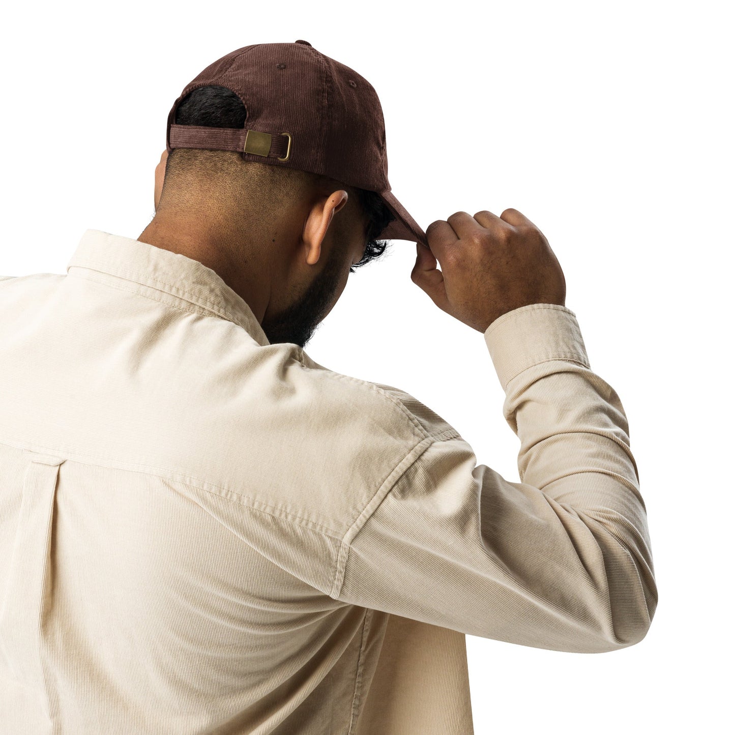 Brown corduroy cap with back strap and gold-tone buckle detail.