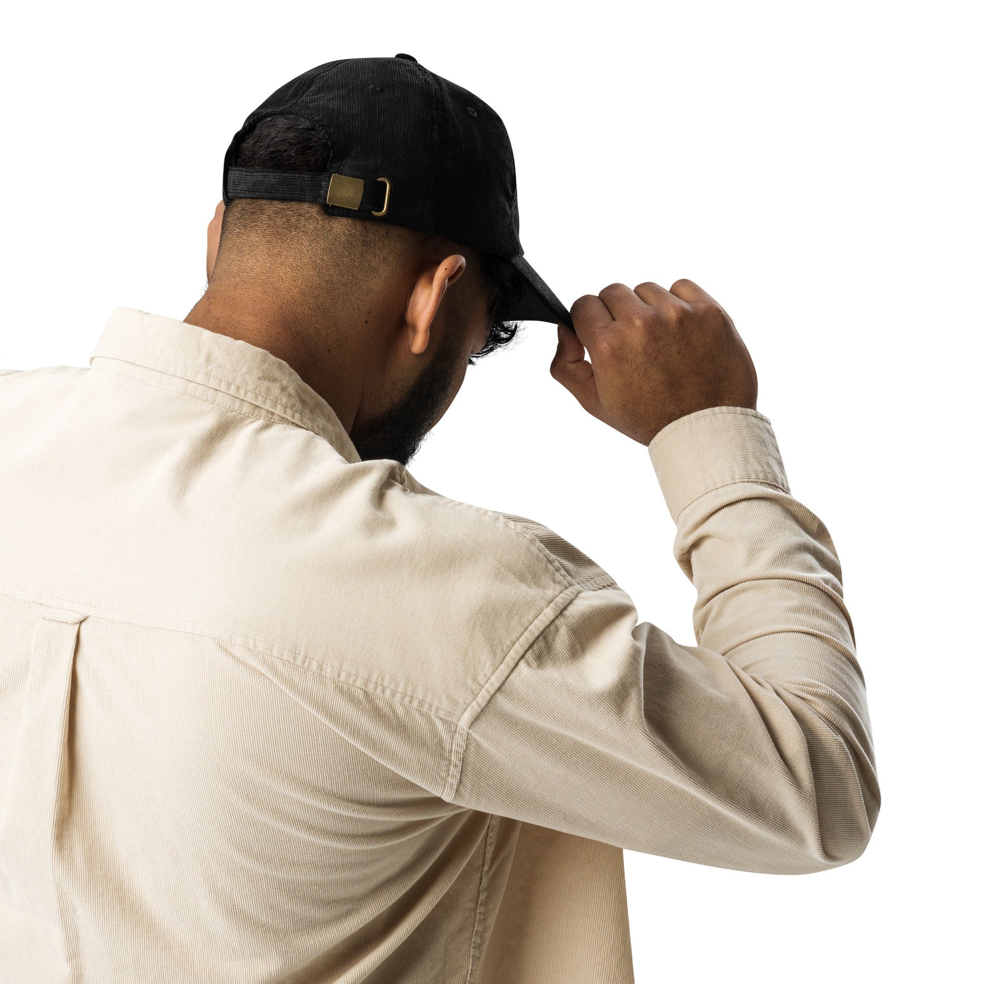 Black corduroy cap with back strap and gold-tone buckle detail.