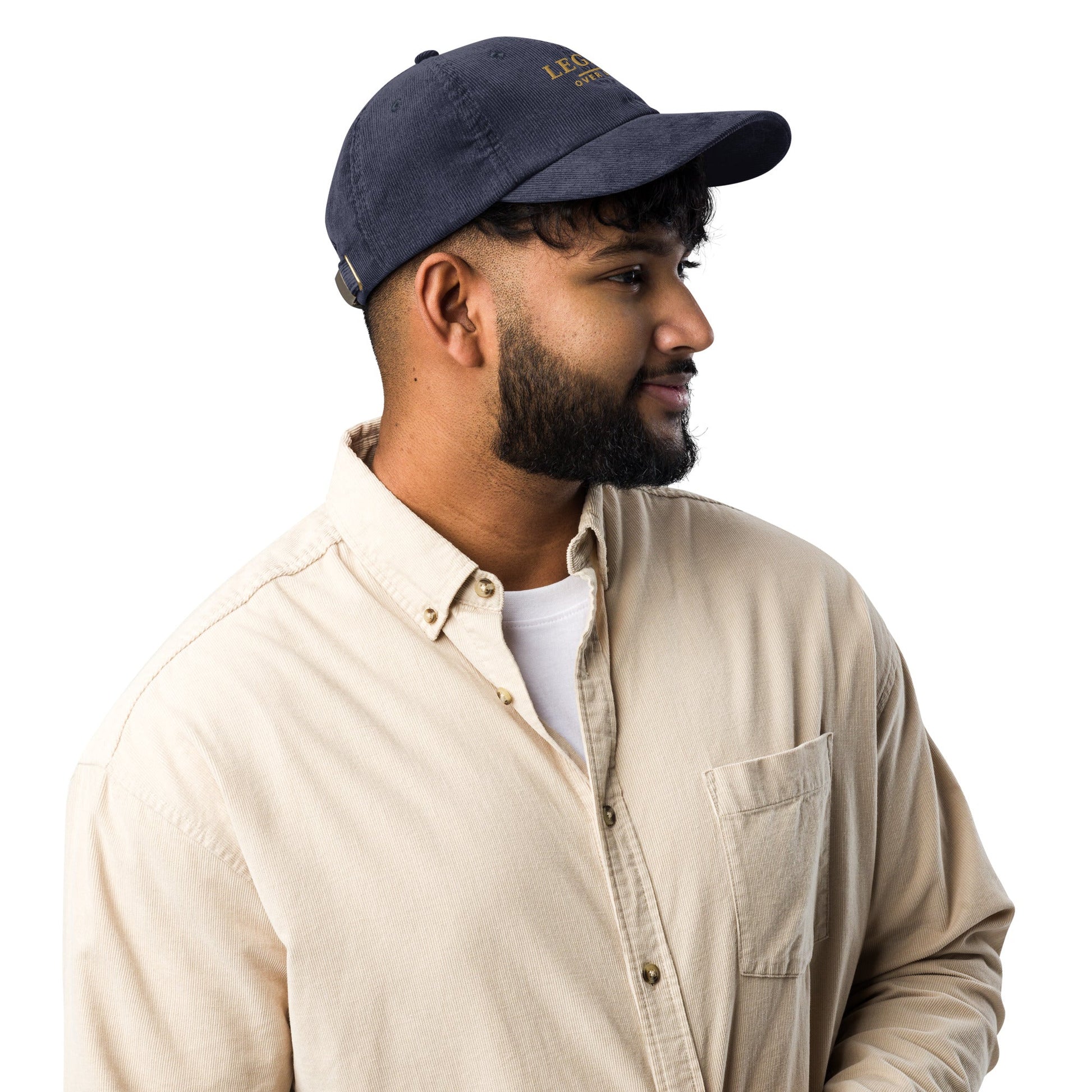Navy corduroy baseball cap, side profile with short brim and stitched eyelets.