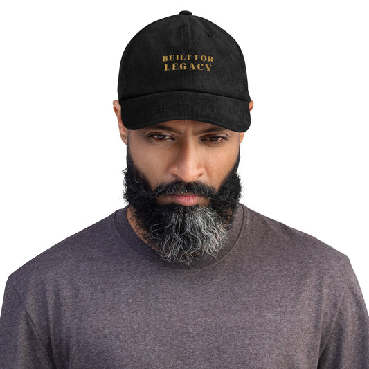 Black corduroy heritage hat with “BUILT FOR LEGACY” embroidered on the front