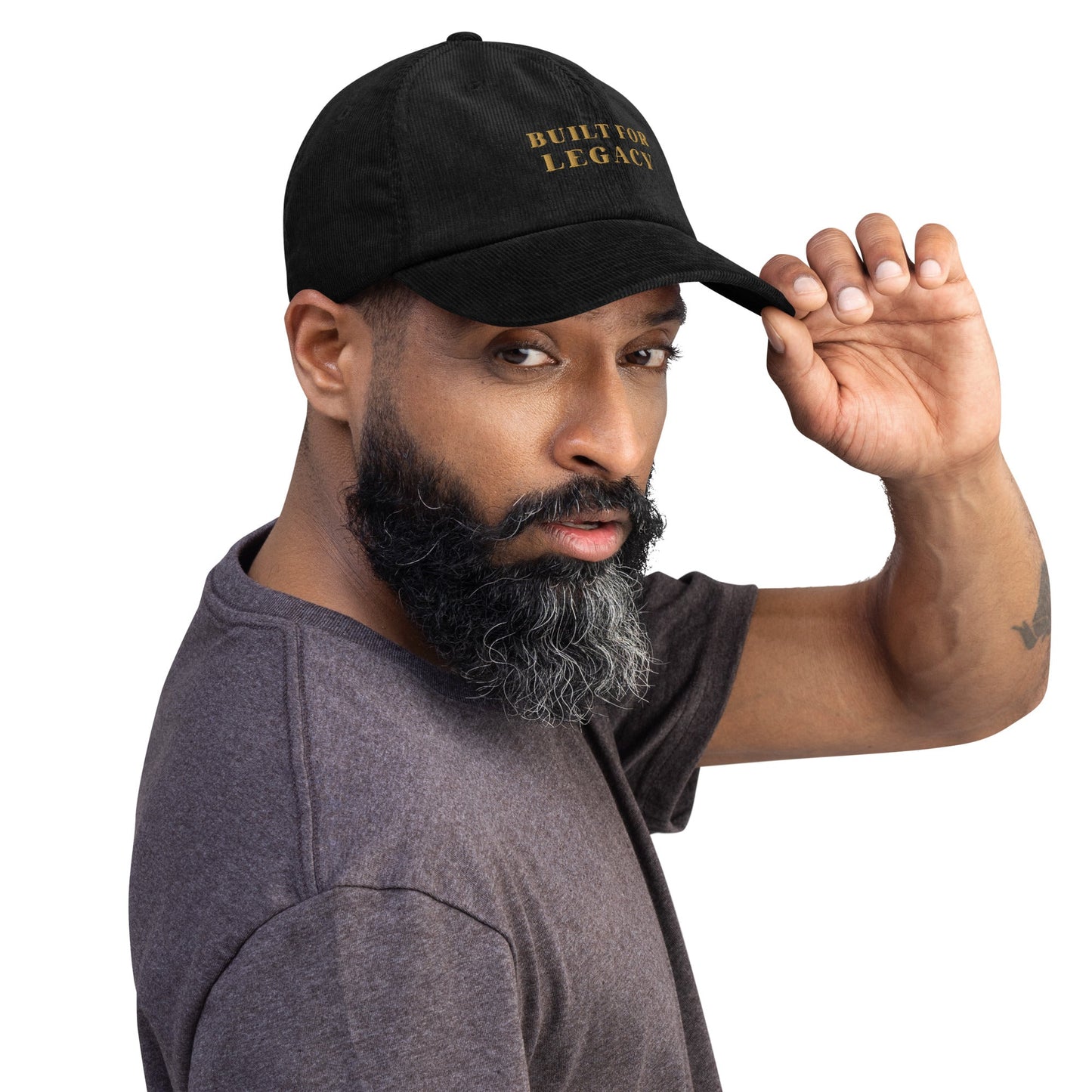 Black corduroy heritage hat with “BUILT FOR LEGACY” embroidery, worn and tilted back