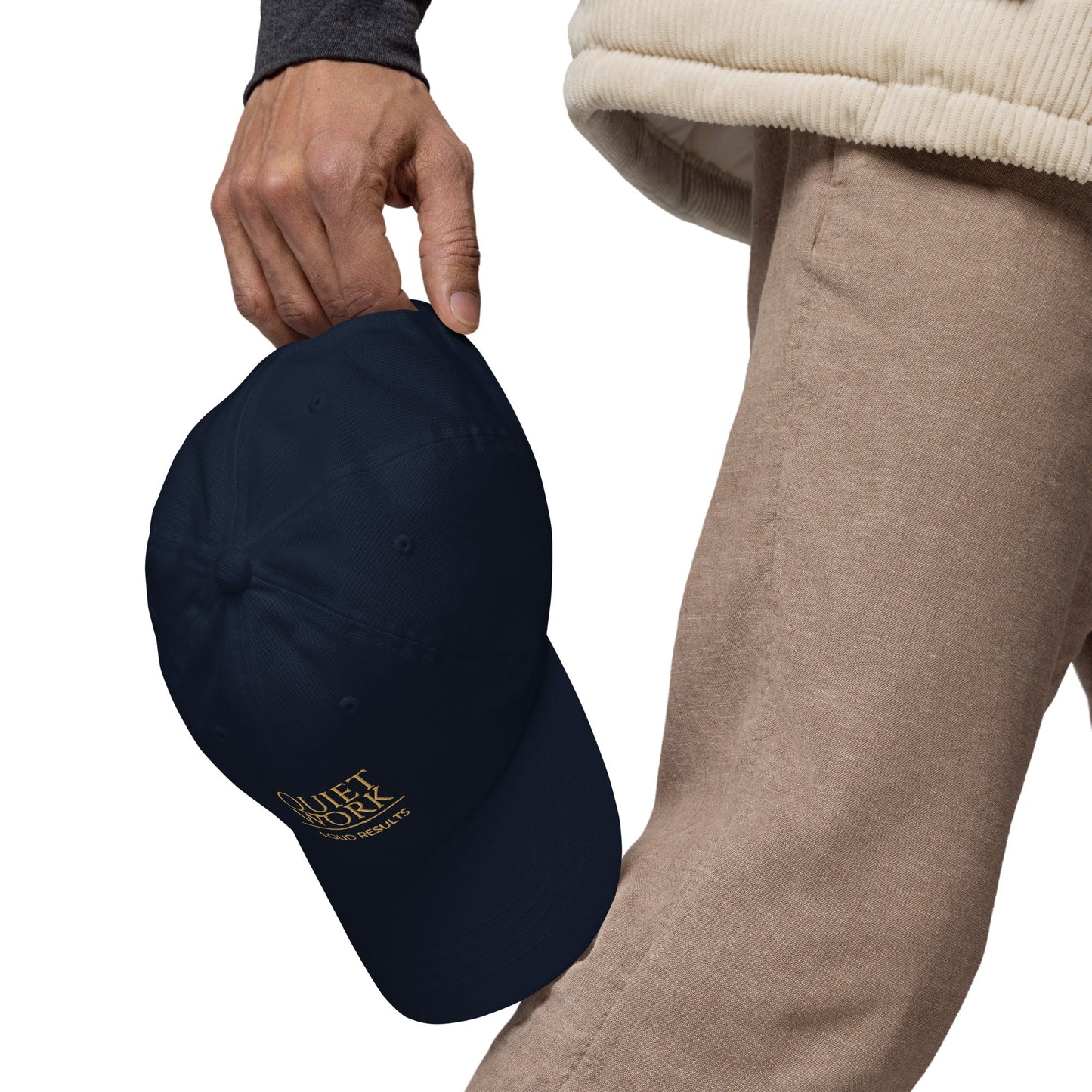 Navy dad hat with curved brim and embroidered logo patch, held in hand