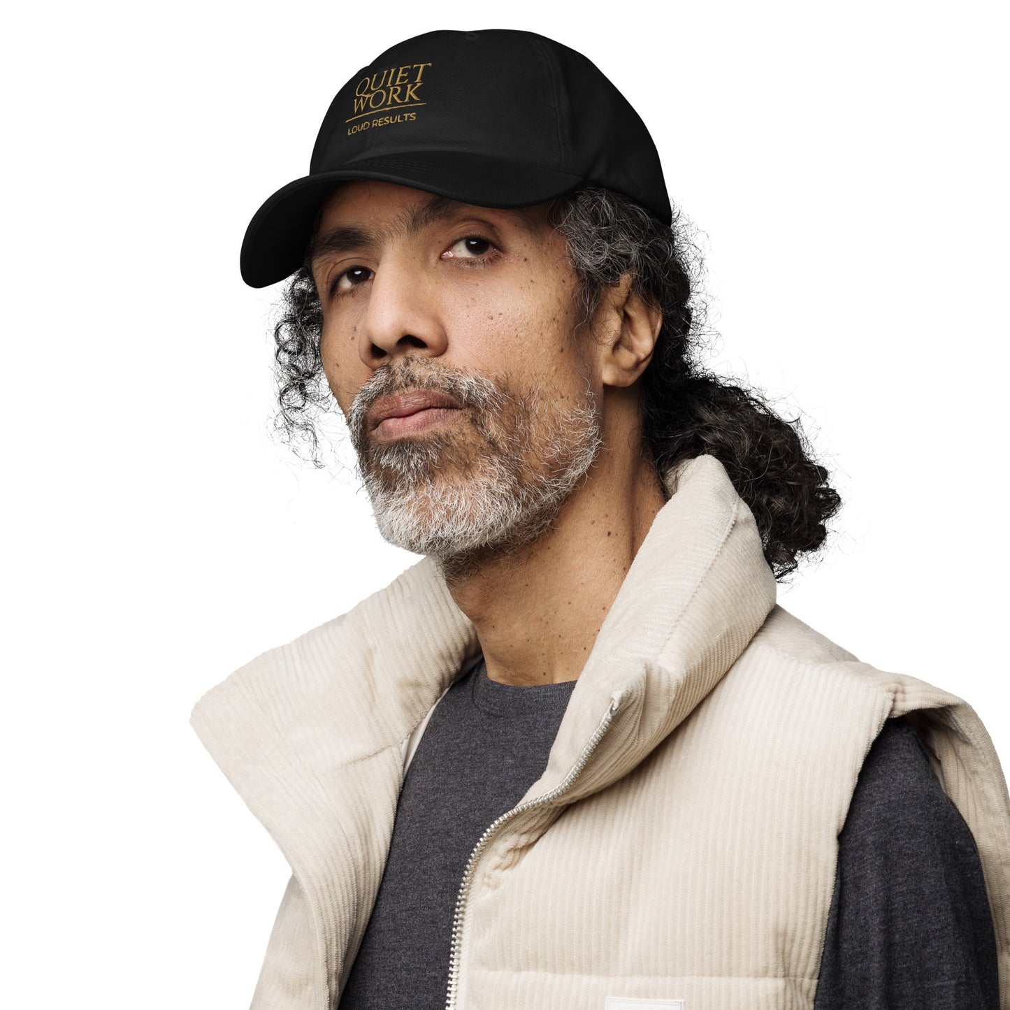 Black dad hat worn by a man, featuring an embroidered logo on the front