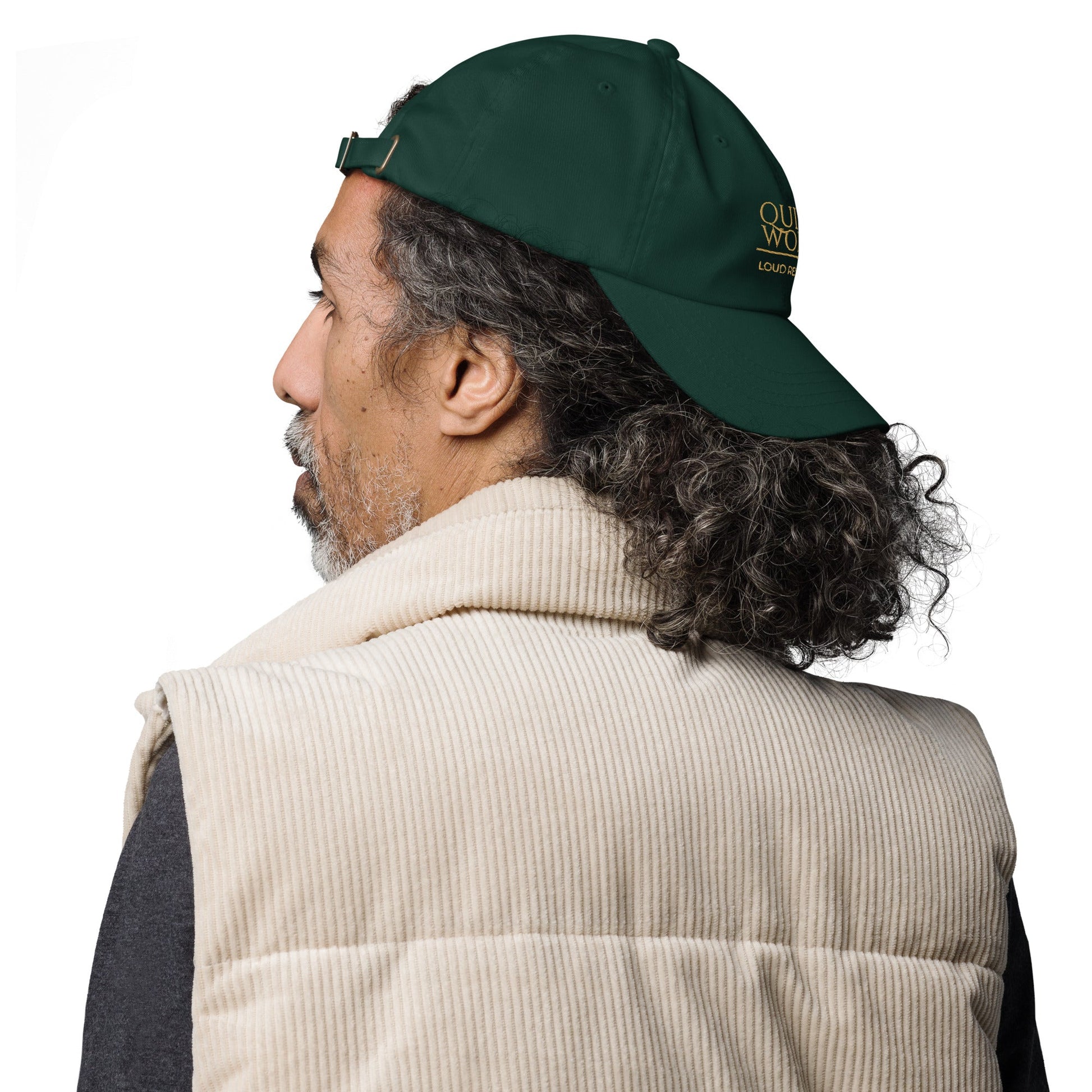 Dark green dad hat from the side with embroidered logo detail on the back