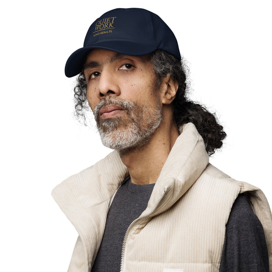 Navy dad hat worn by a man, featuring an embroidered logo on the front