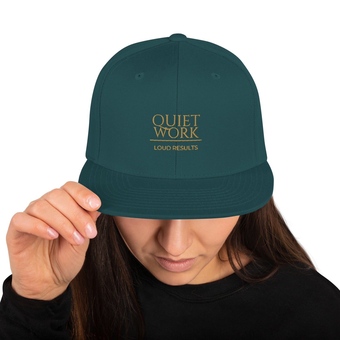 Dark teal snapback cap with front text logo and curved brim
