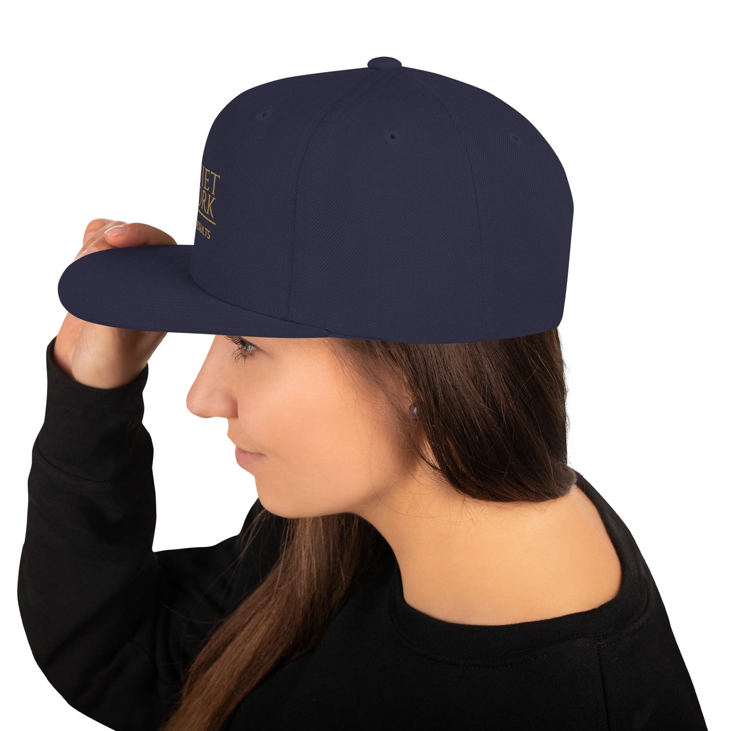 Dark navy snapback cap with curved brim and small side embroidery