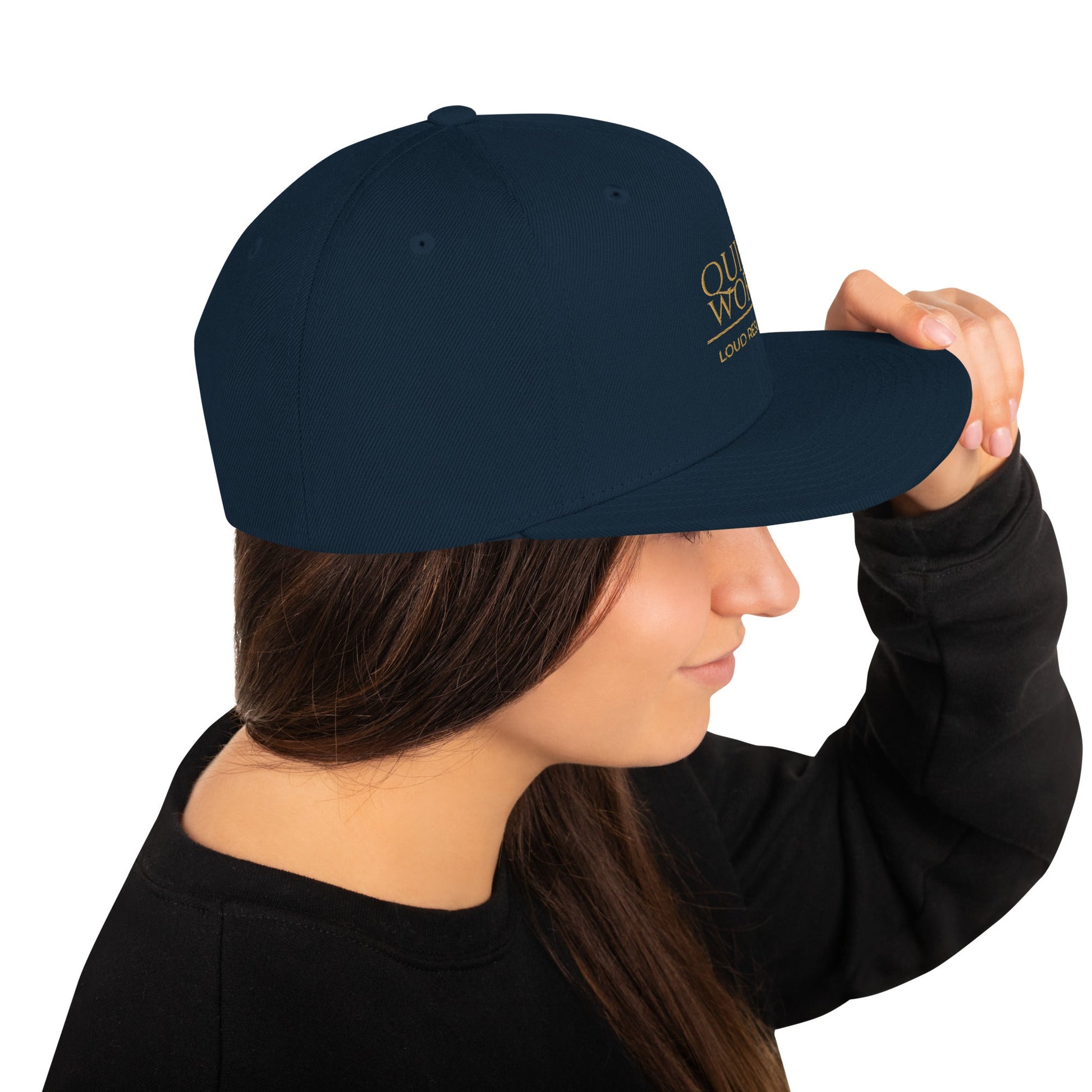 Dark navy snapback cap, angled side view with crown logo print